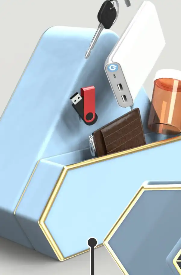 The device's hexagonal storage tray holding keys, a wallet, a USB drive, a battery pack and a pill bottle.